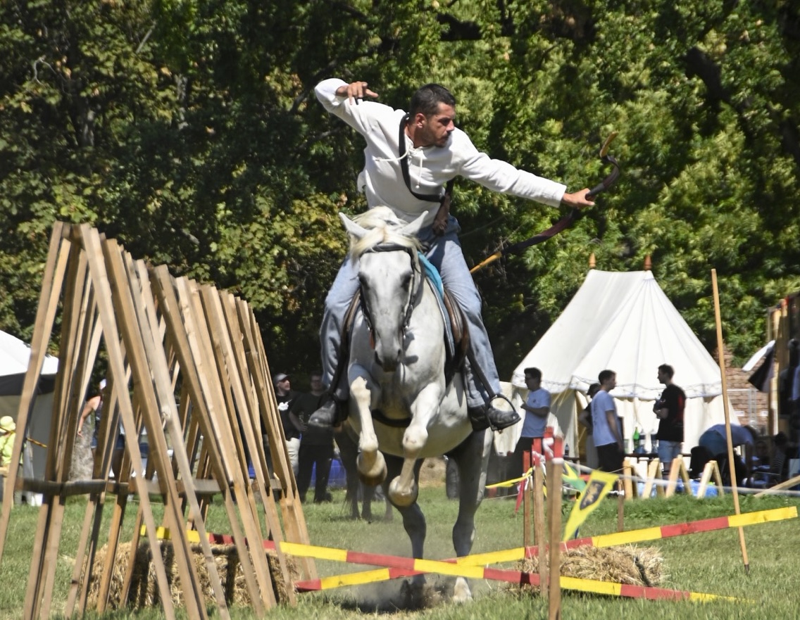 A mounted archer riding the track at a gallop