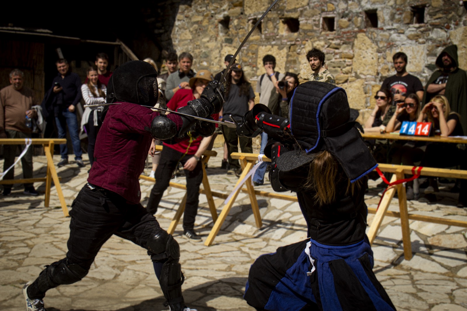 A longsword exchange in a fortress courtyard during a tournament bout